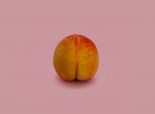 Peach image on pink background about anal play